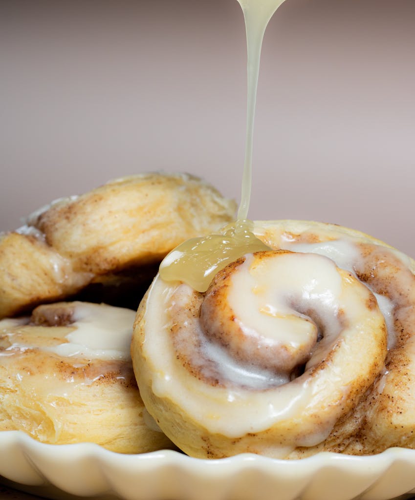 Close-Up Photo of Cinnamon Rolls with Cream